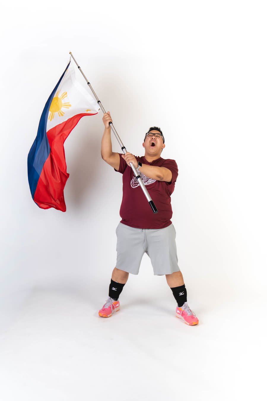 Player raising the Philippine flag at media day
