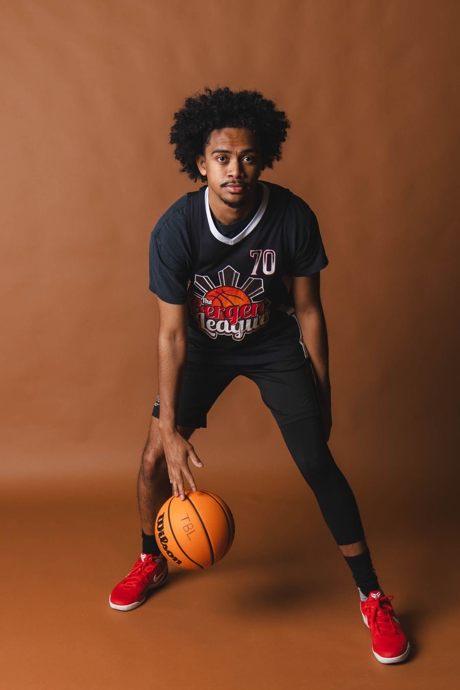 Studio portrait, ball low, eyes on camera