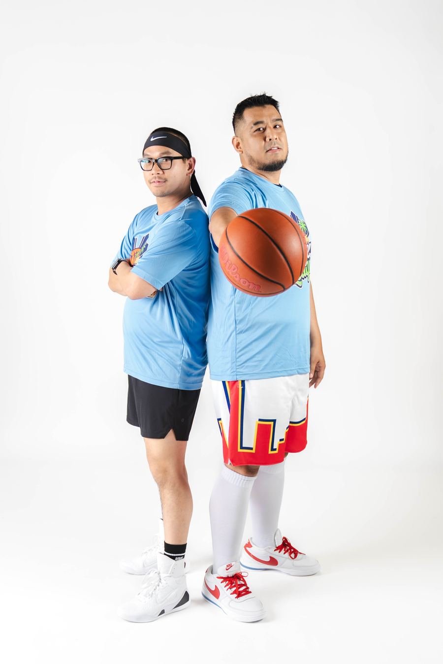 Two players back to back with a basketball, media day