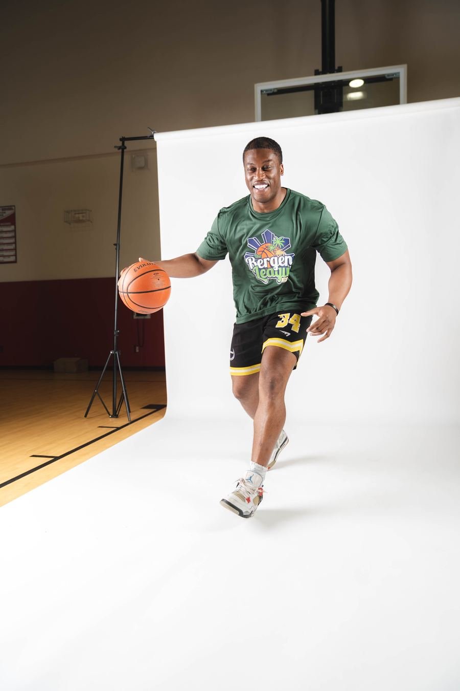 Player in green dribbling, studio shot