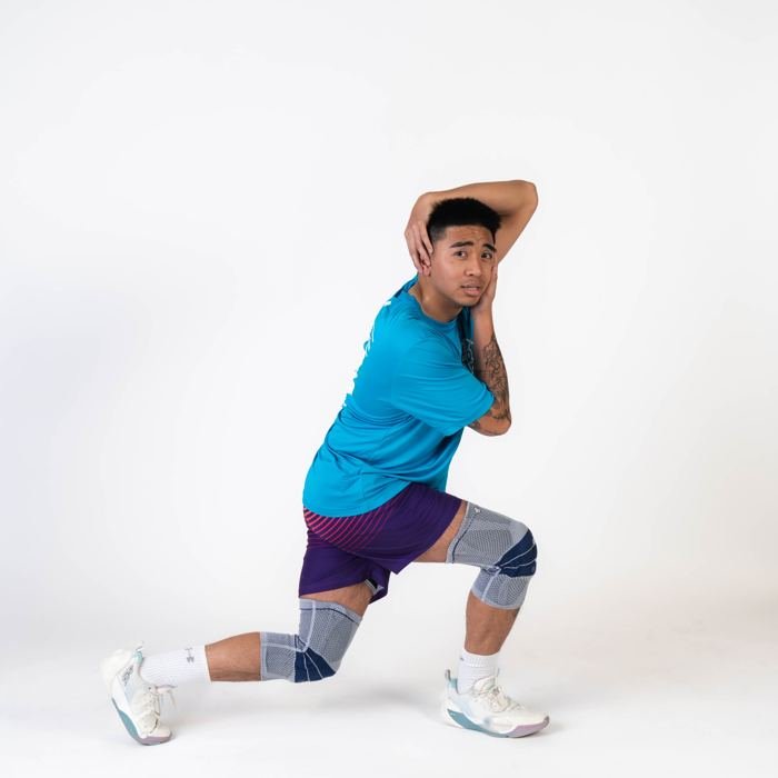 Media-day portrait, lunge stretch in teal