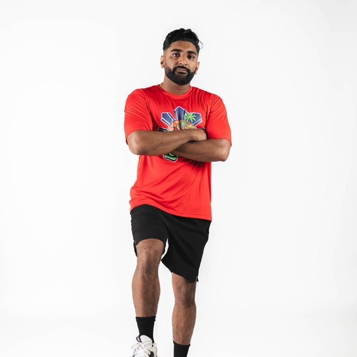 Media-day portrait, arms crossed in red